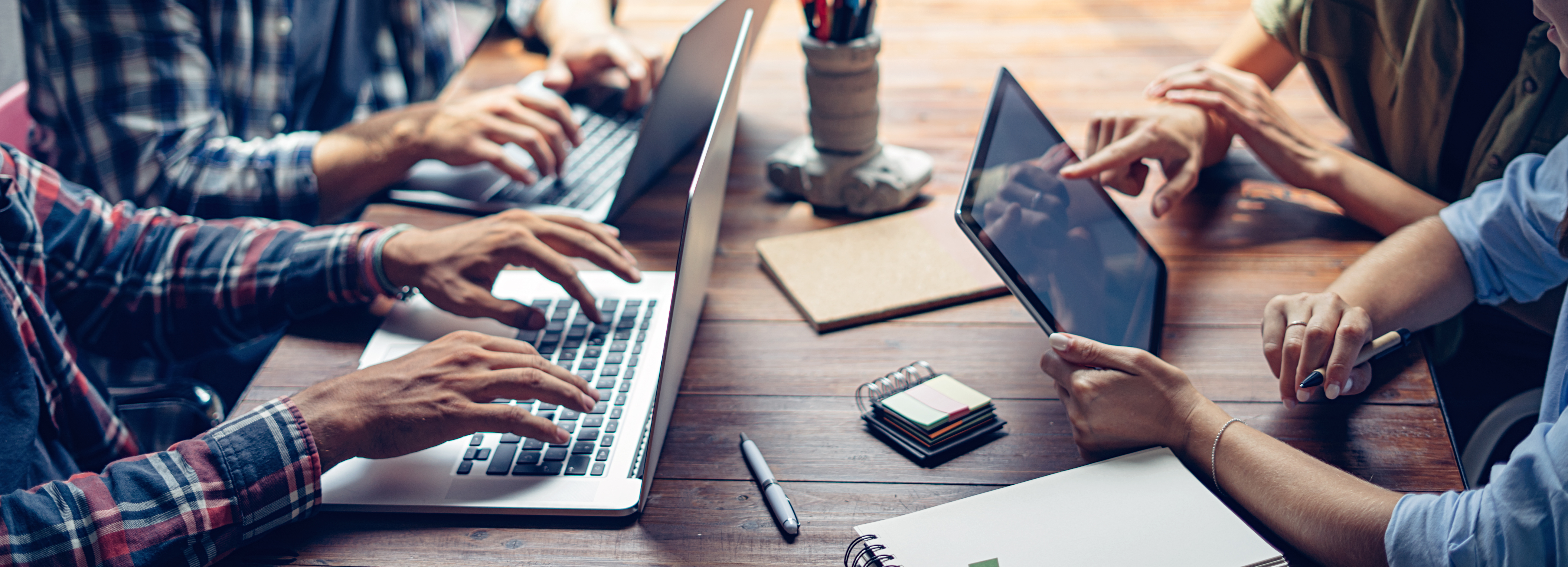 Group of young people working together. Creative business people in modern office. Hipster team in coworking. Colleagues at work.