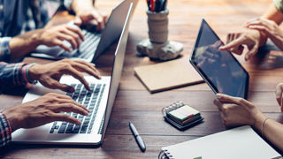 Group of young people working together. Creative business people in modern office. Hipster team in coworking. Colleagues at work.